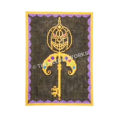 skeleton key on black background with yellow jackolantern