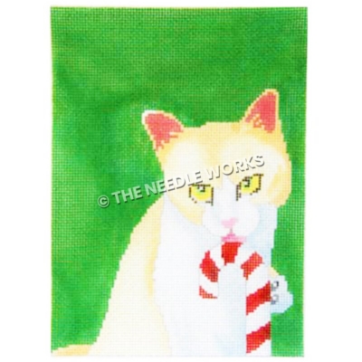 yellow and white cat licking candy cane on green background