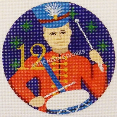 blue ornament with drummer boy in red suit and blue hat with gold 12 and green snowflakes