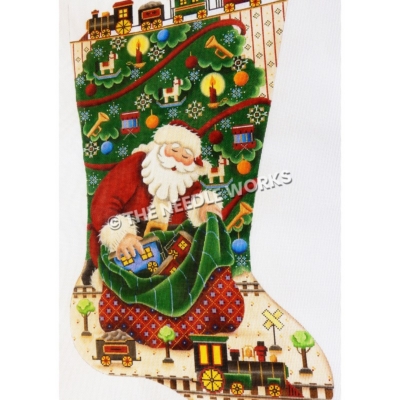 stocking with Santa pulling train cars from bag of toys next to toy train with Christmas tree in background and train framing the top