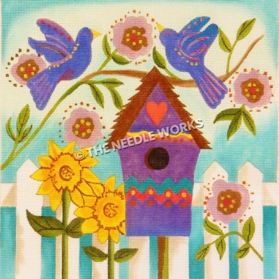purple birds with red and yellow patterns sitting on branch with pink and brown flowers above a purple birdhouse with a red heart and white vence with sunflowers and pink and brown flowers