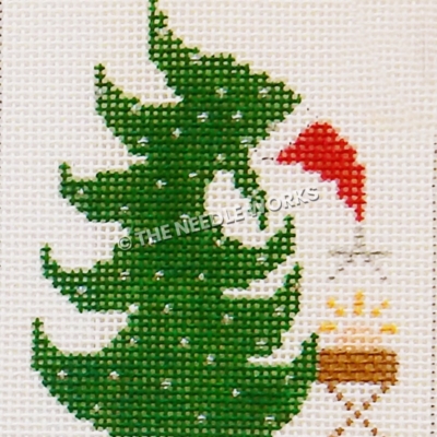 Christmas tree wearing Santa hat bent over to hand star from top to Jesus in manger