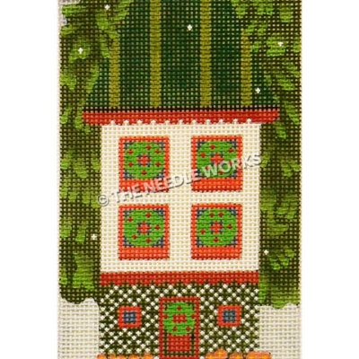 white two story house with green striped roof and wreaths on each window and door with tall evergreens on each side