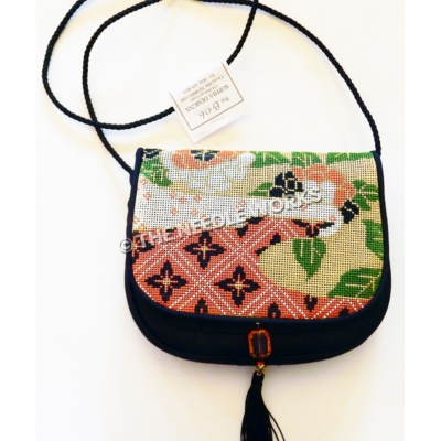 purse with red, black, gold and white pattern, green leaves, and red, white and black flowers