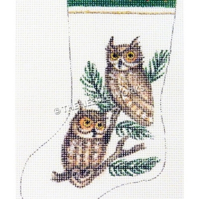 white stocking with two owls on pine branch and green and gold trim at top