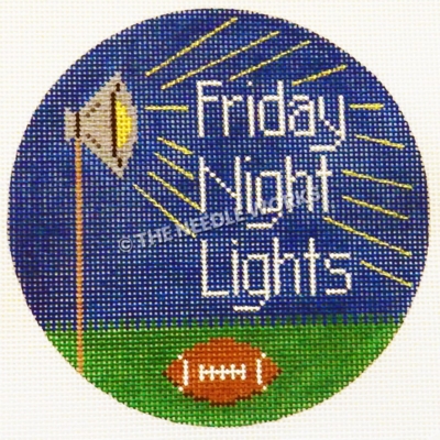 round ornament with Friday Night Lights next to stadium light on dark blue sky and football on ground below