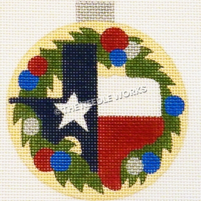 yellow ornament with shape of Texas with Texas flag colors and wreath with red, blue, and white ornament balls