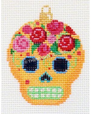 orange skull with pink and red roses on top of head with green and white mouth