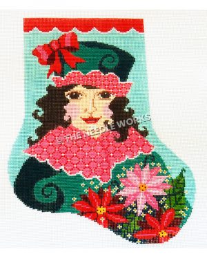 teal stocking with red trim and brunette woman wearing green dress with red and white collar and green hat with red and white trim holding poinsettia plant