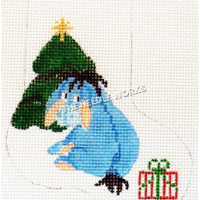white stocking with Eeyore sitting in front of Christmas tree with red, white and green present