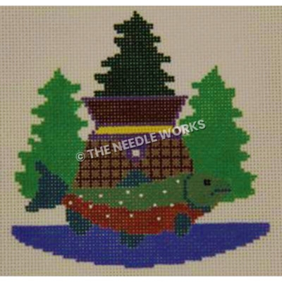 green and red fish in front of building and three evergreen trees