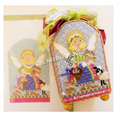 blonde angel in green, pink, purple and yellow patchwork dress carrying a brown bunny and basket of Easter eggs with sheep and bunny at her feet