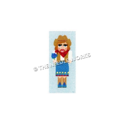 Texas cowgirl nutcracker wearing blue, white and brown dress holding bluebonnets
