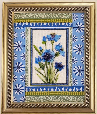 blue flowers on white rectangle with green, white, blue, and gold geometric patterned borders in gold frame