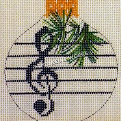 white round ornament with dark blue treble clef and music staff with pine leaves