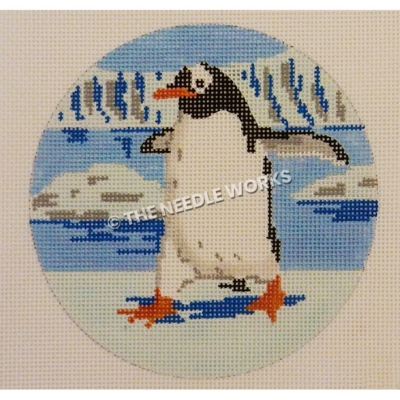 ornament with penguin strutting on snowy landscape with water and glaciers in background