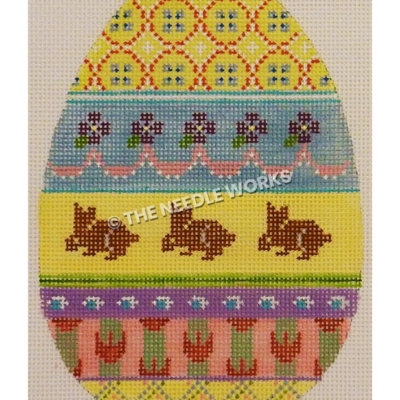 yellow Easter egg with plaid pattern at top and bottom, blue band with purple flowers and pink ribbons, purple rabbits on yellow band, and green, purple and pink bands with decorations