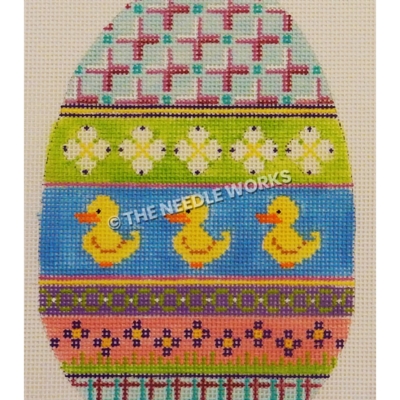multi-colored Easter egg with blue and purple plaid at top and bottom, green band with white flowers, yellow ducks on blue band, purple and pink bands with green and purple decorations