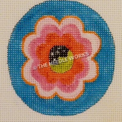 blue ornament with pink and red flower with black and lime green center