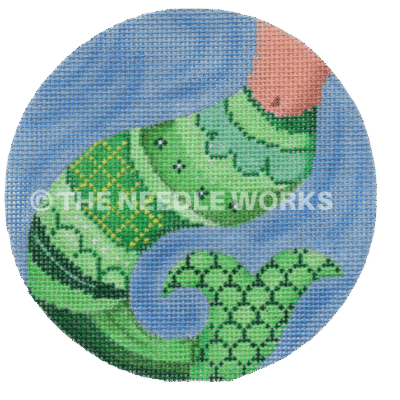 round ornament with green mermaids tail on blue background