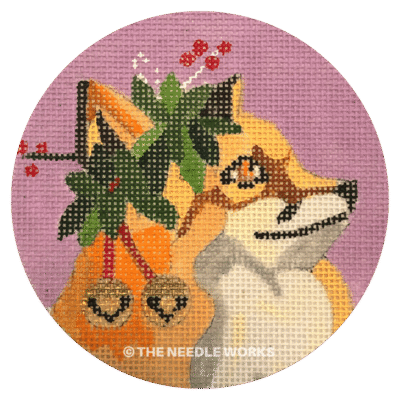 round ornament with fox wearing mistletoe and bells