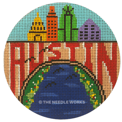 round ornament with Austin written in red on Congress bridge with bats flying out and city skyline