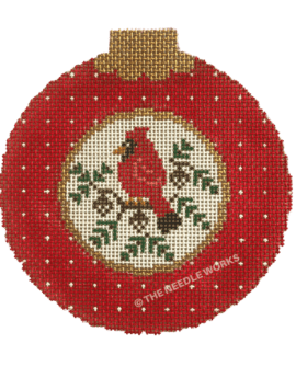round ornament in red with white circle in the middle with red cardinal on a branch