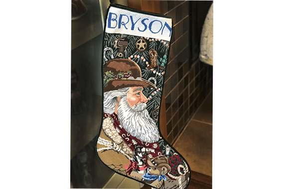 stocking finishing project with Santa and Bryson at top