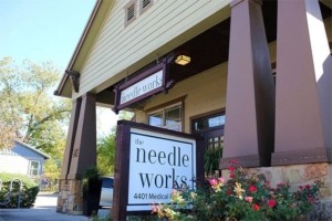 the needle works shop sign